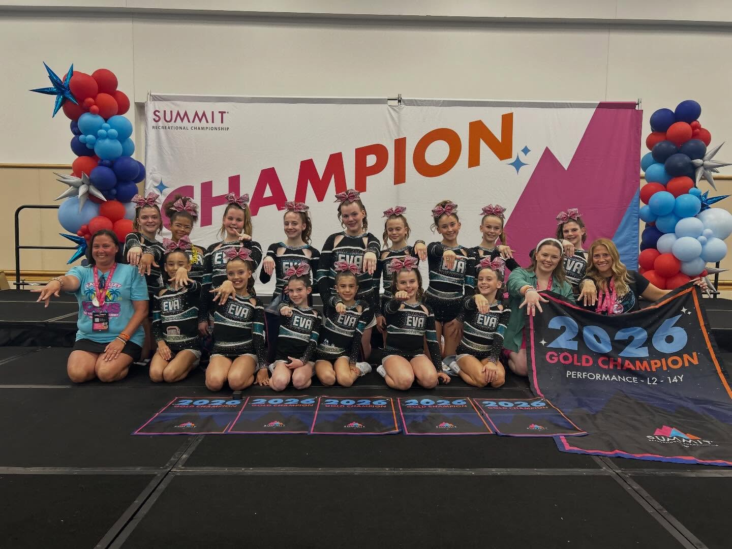 EVA team on stage with coaches at Summit Recreational Championship, 2026 Gold Champion