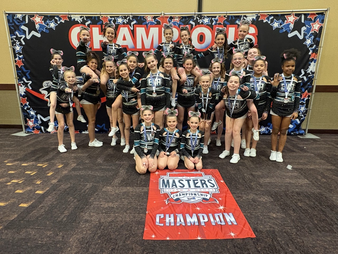 EVA team with Masters Champion banner