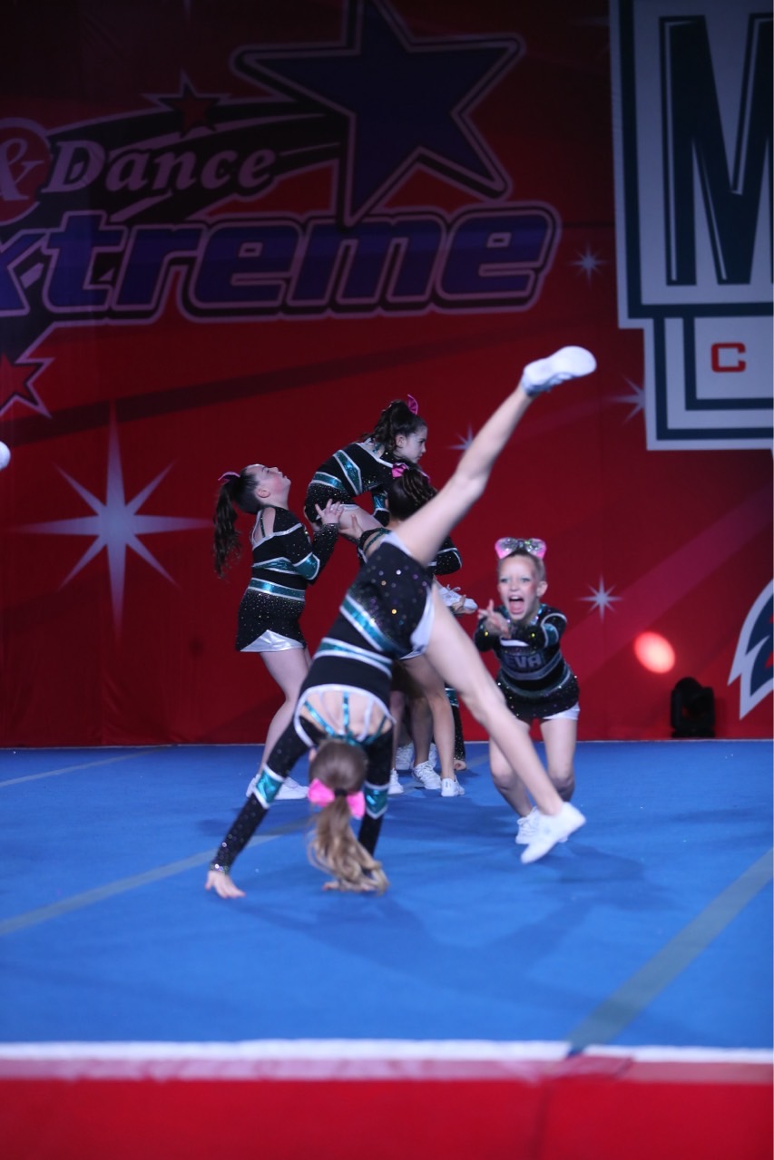EVA athletes performing a stunt on the competition floor